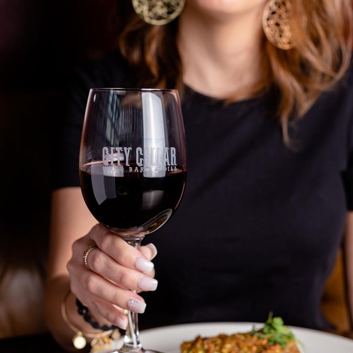 Woman holding glass of red wine 