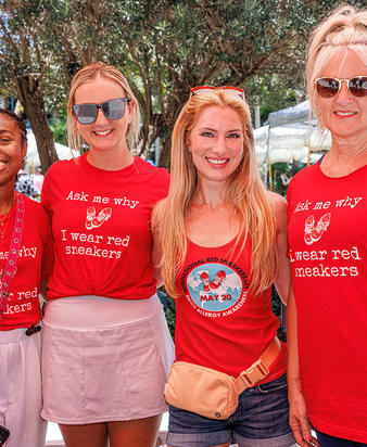 Four women in red shirts