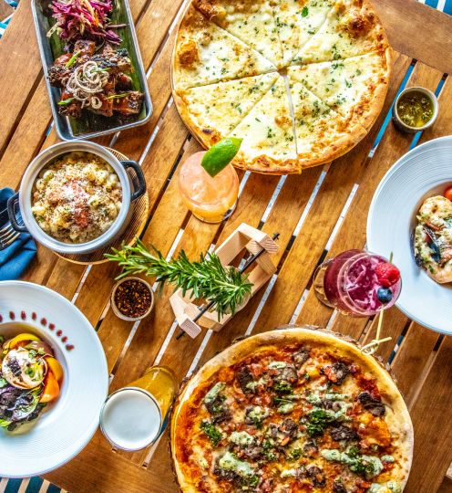 pizza and accompaniments on wooden table