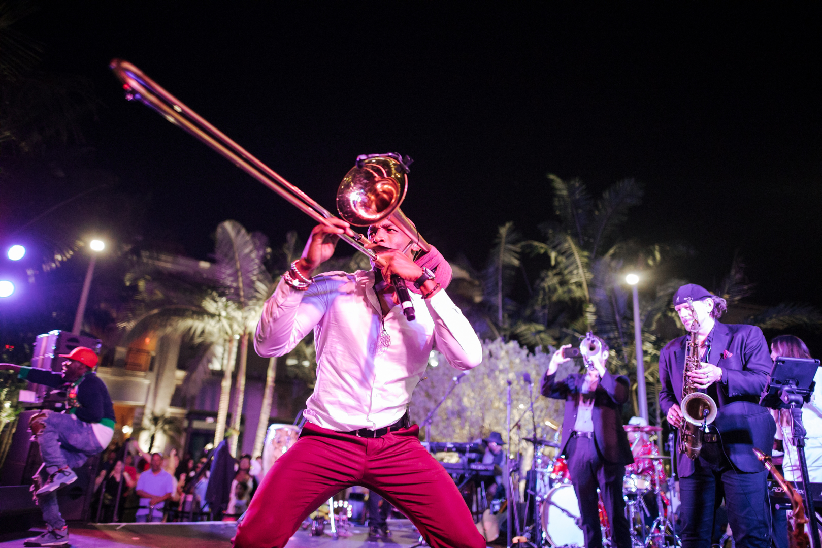 Trombone players with band in the background