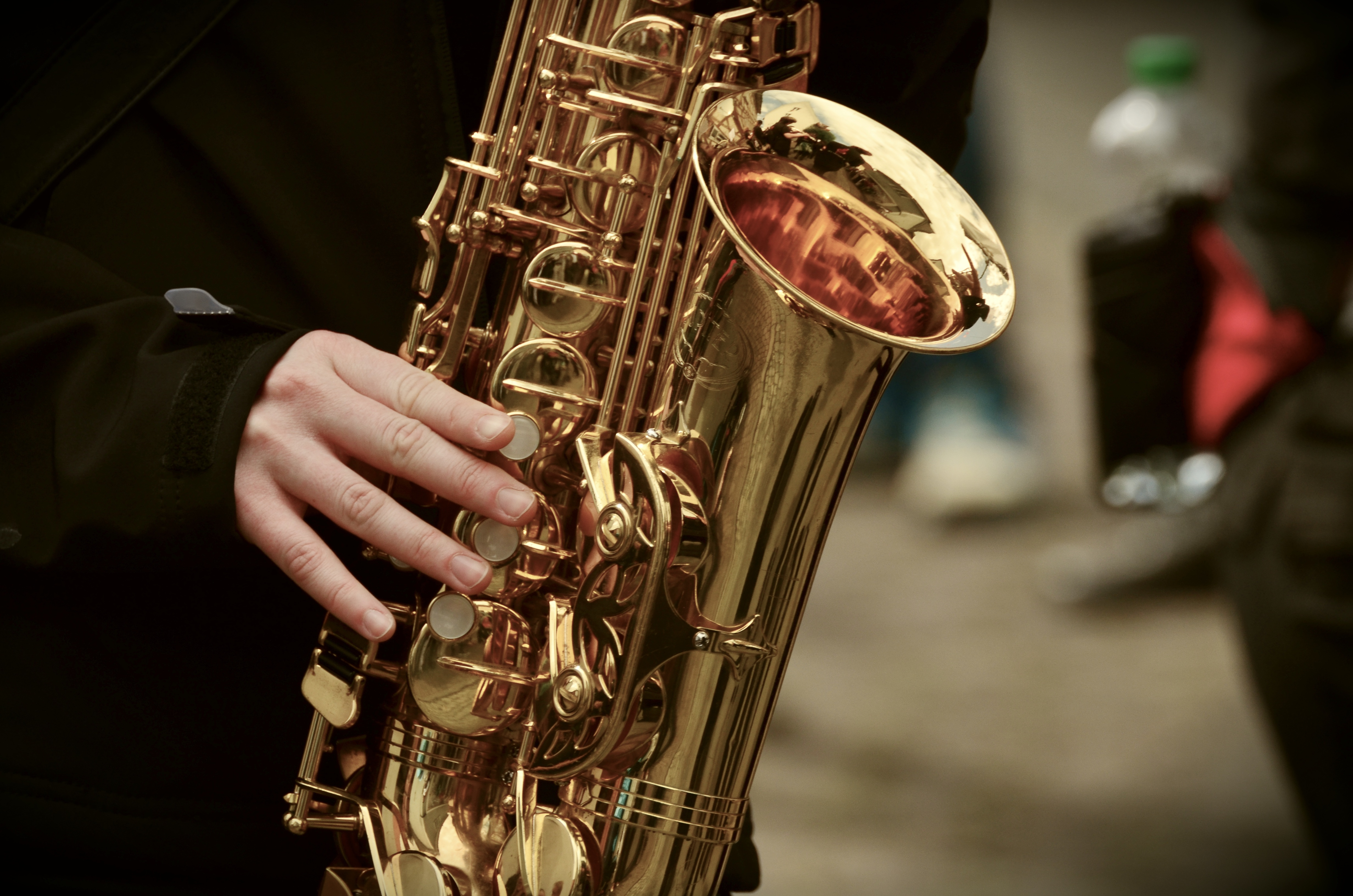 Person holding a saxophone