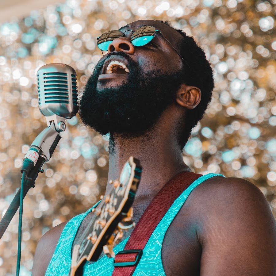Guitarist singing into microphone