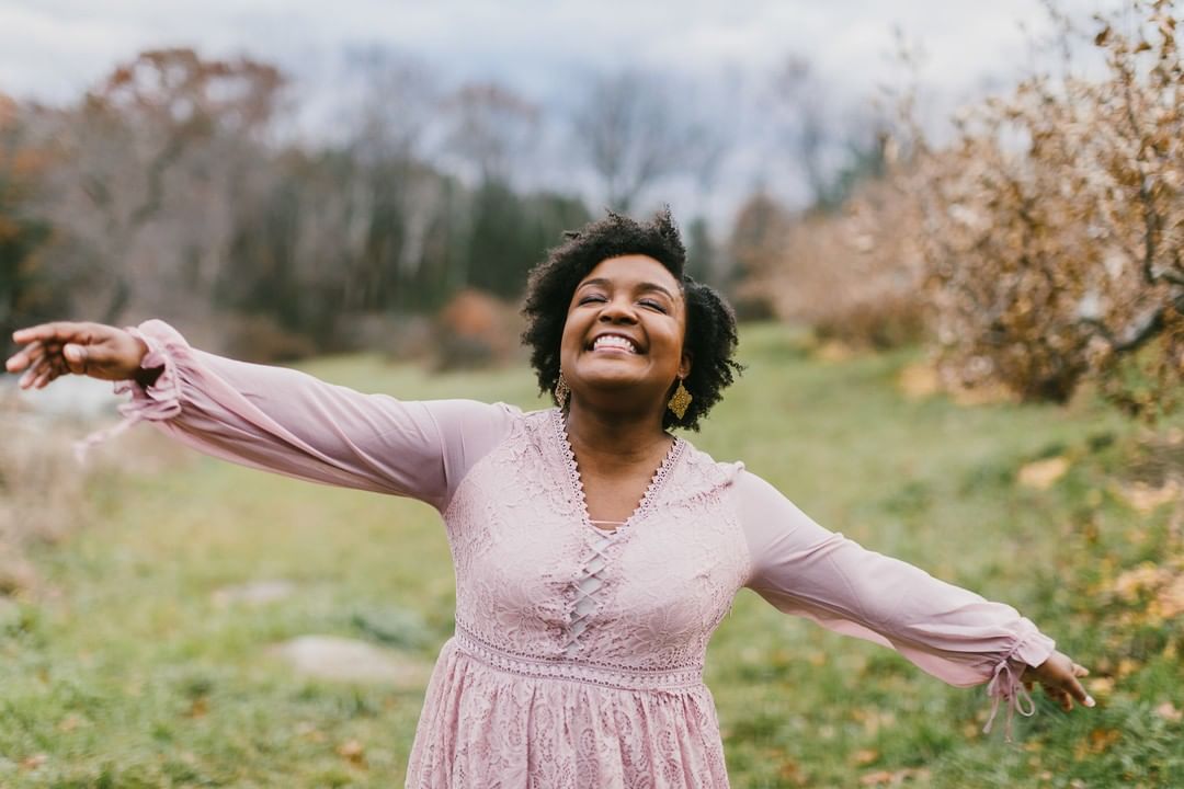 Woman smiling with arms wide open