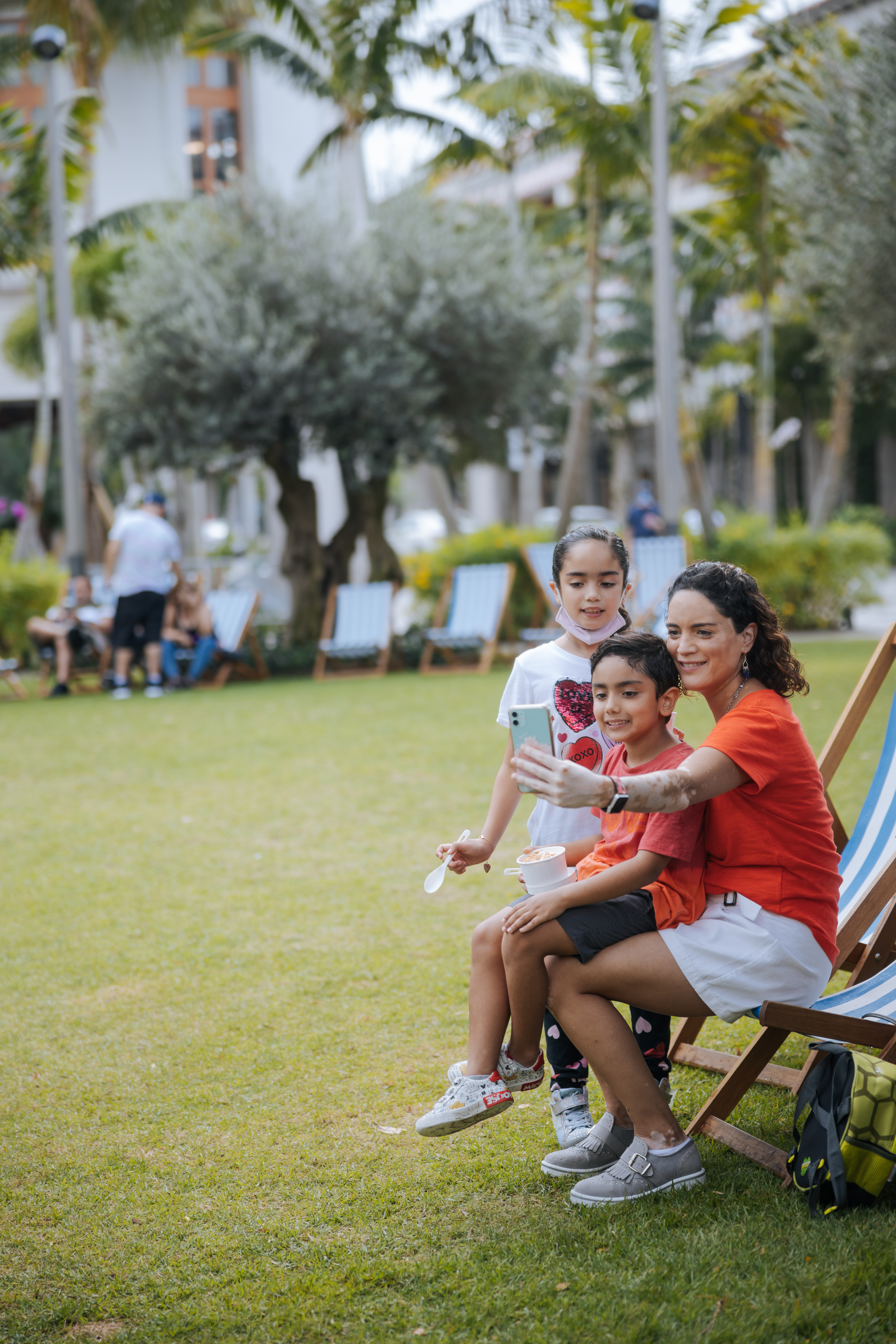 Mother taking selfie with young children