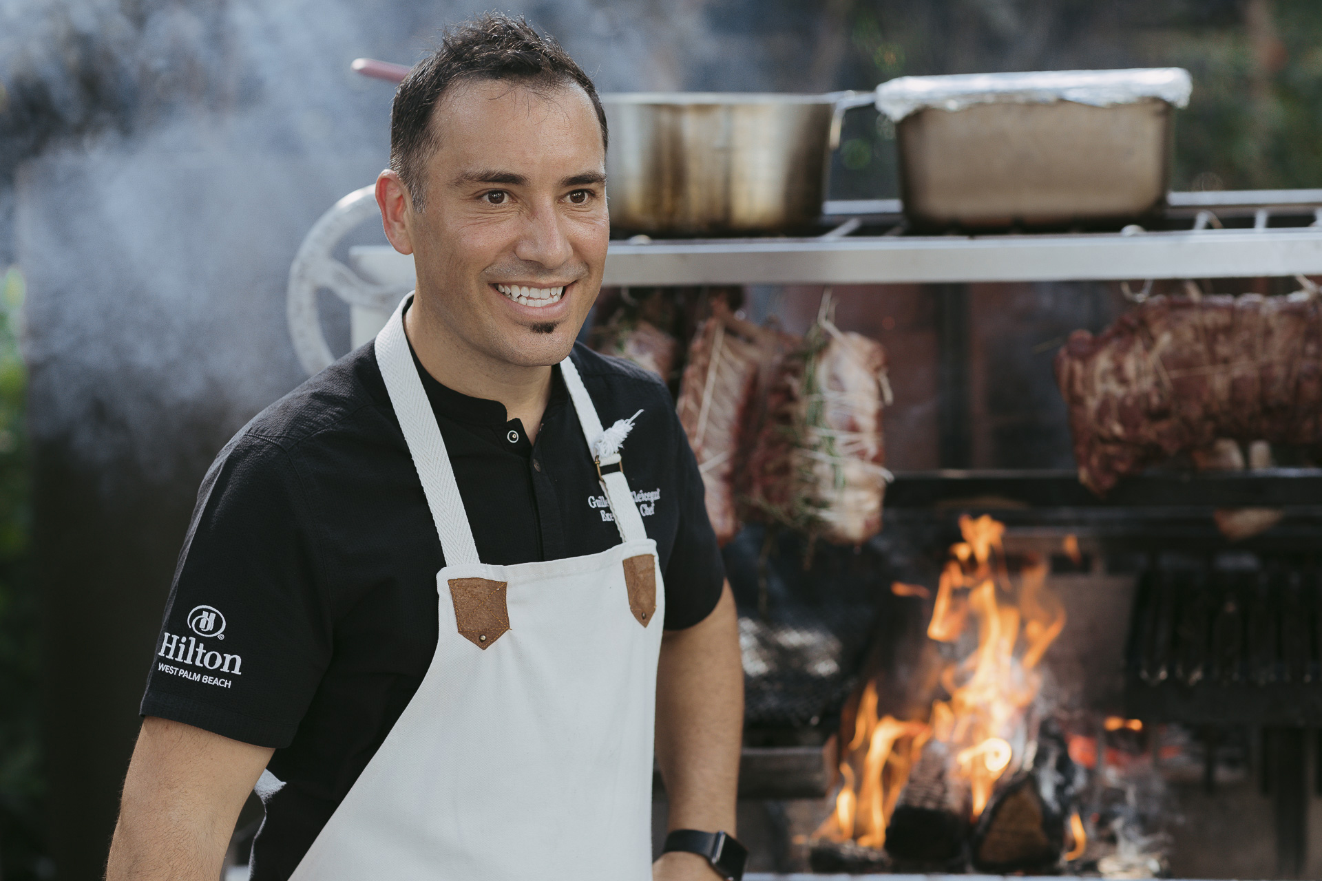 Chef sitting in front of grill