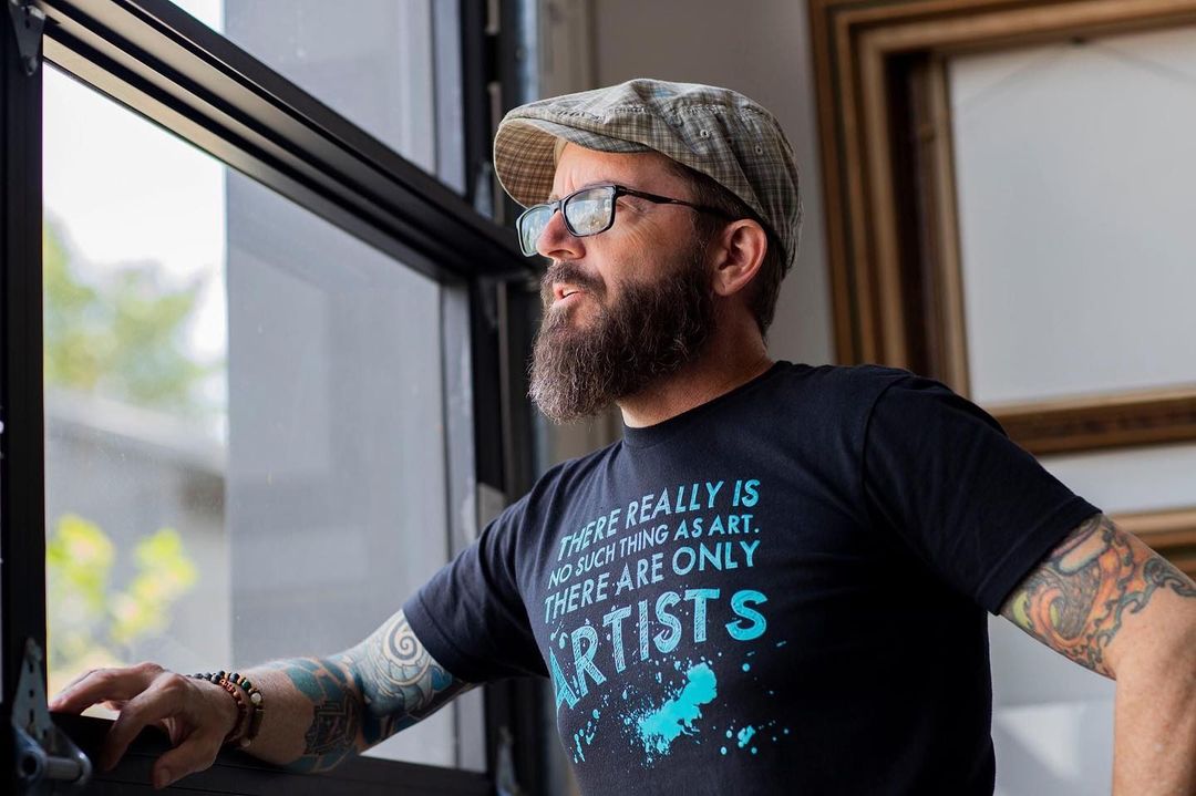 Artist looking out window