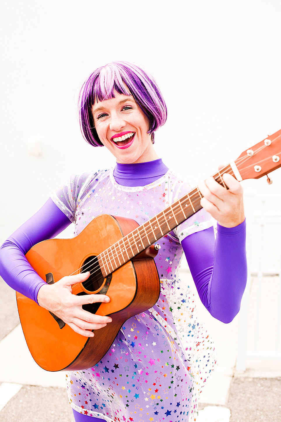 performer with guitar dresses as out of this world super hero 