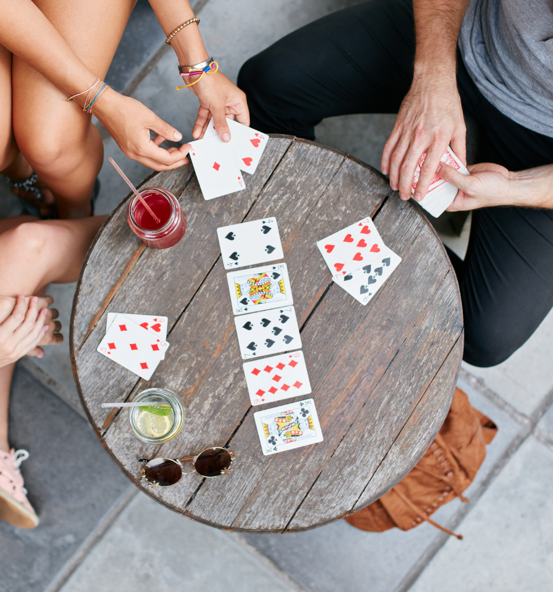 three people playing cards 