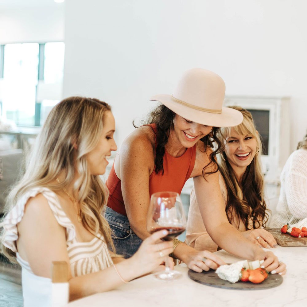 women creating charcuterie board