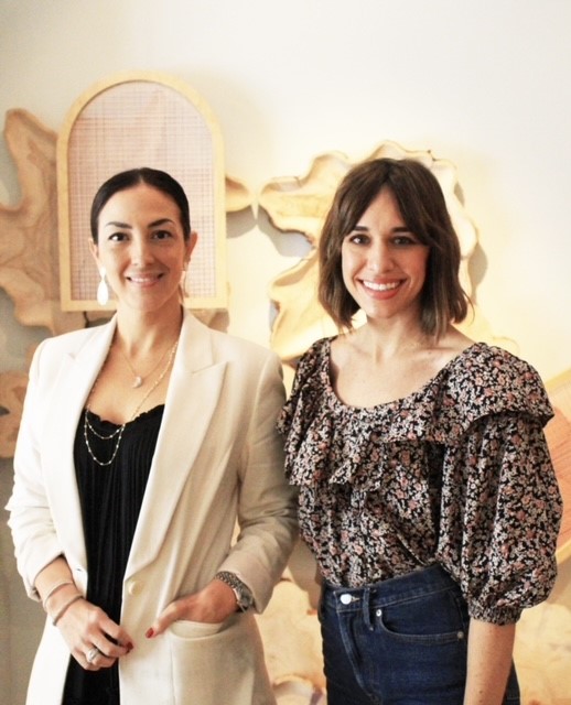 Two women artists posing in studio