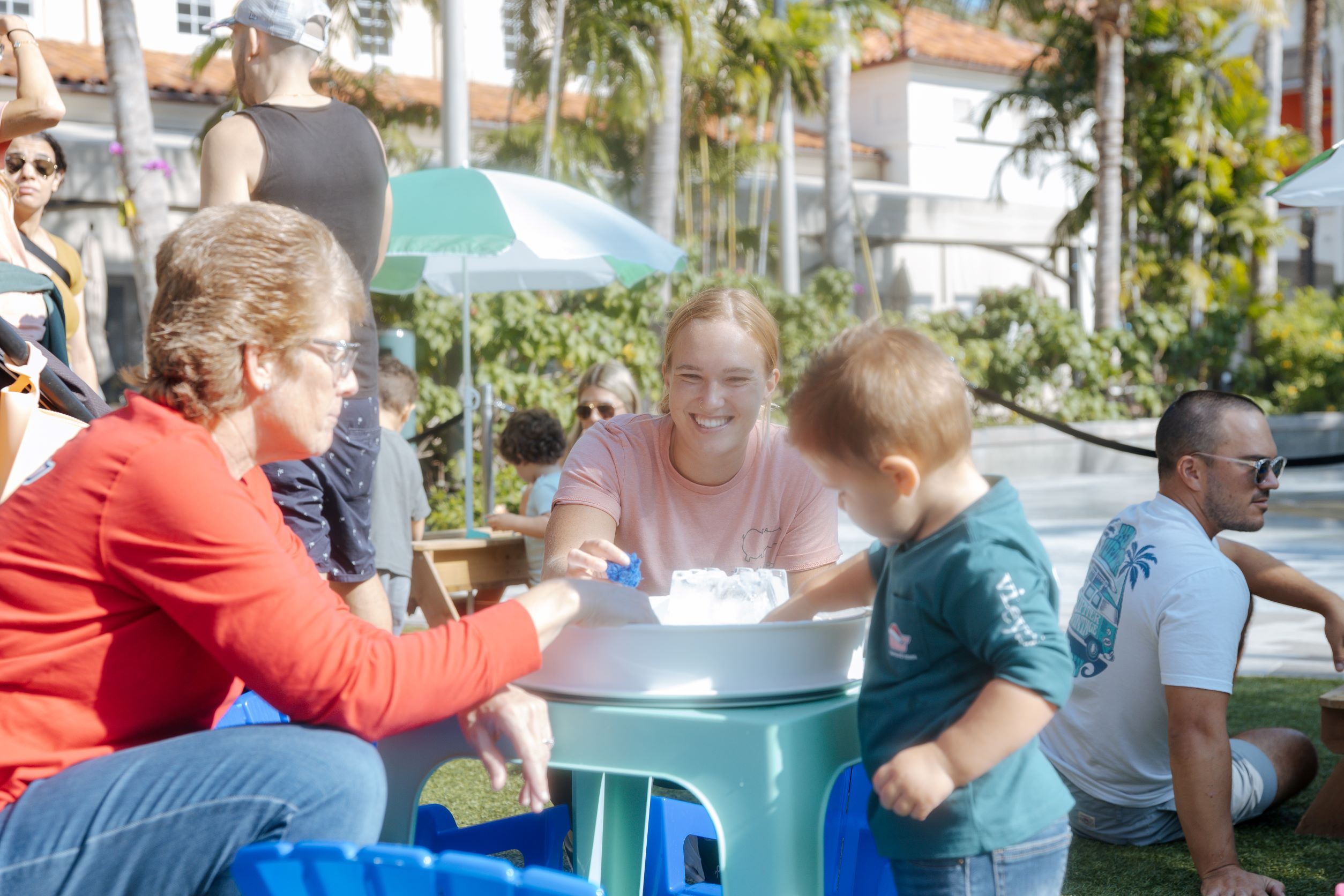 individuals doing sensory play with a child