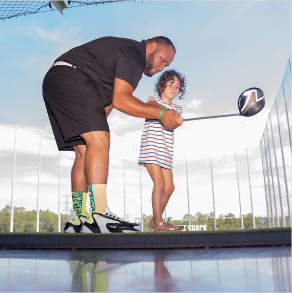 Father and daughter at Drive Shack