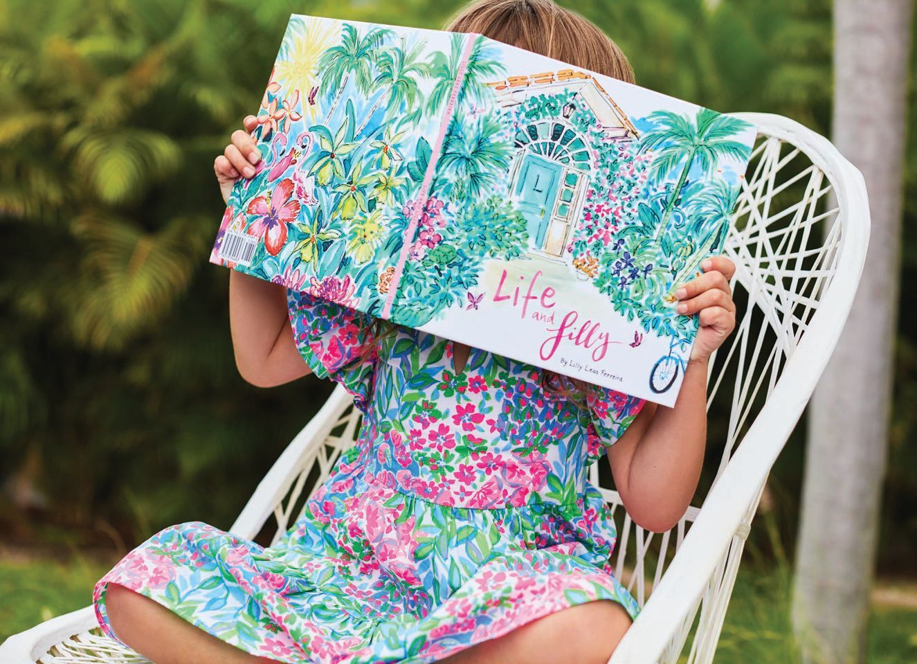 Girl sitting in a chair reading a book