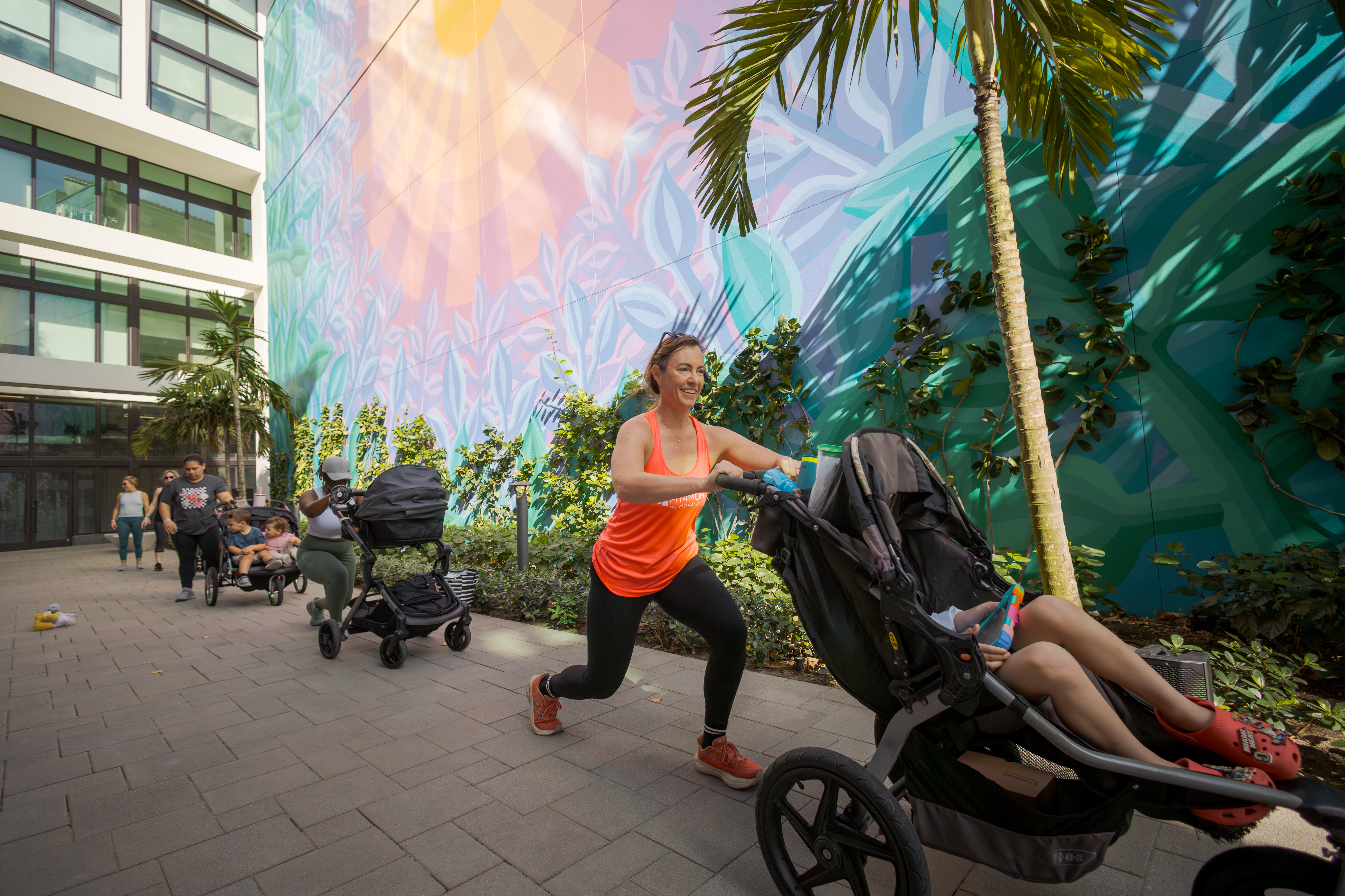 women pushing strollers