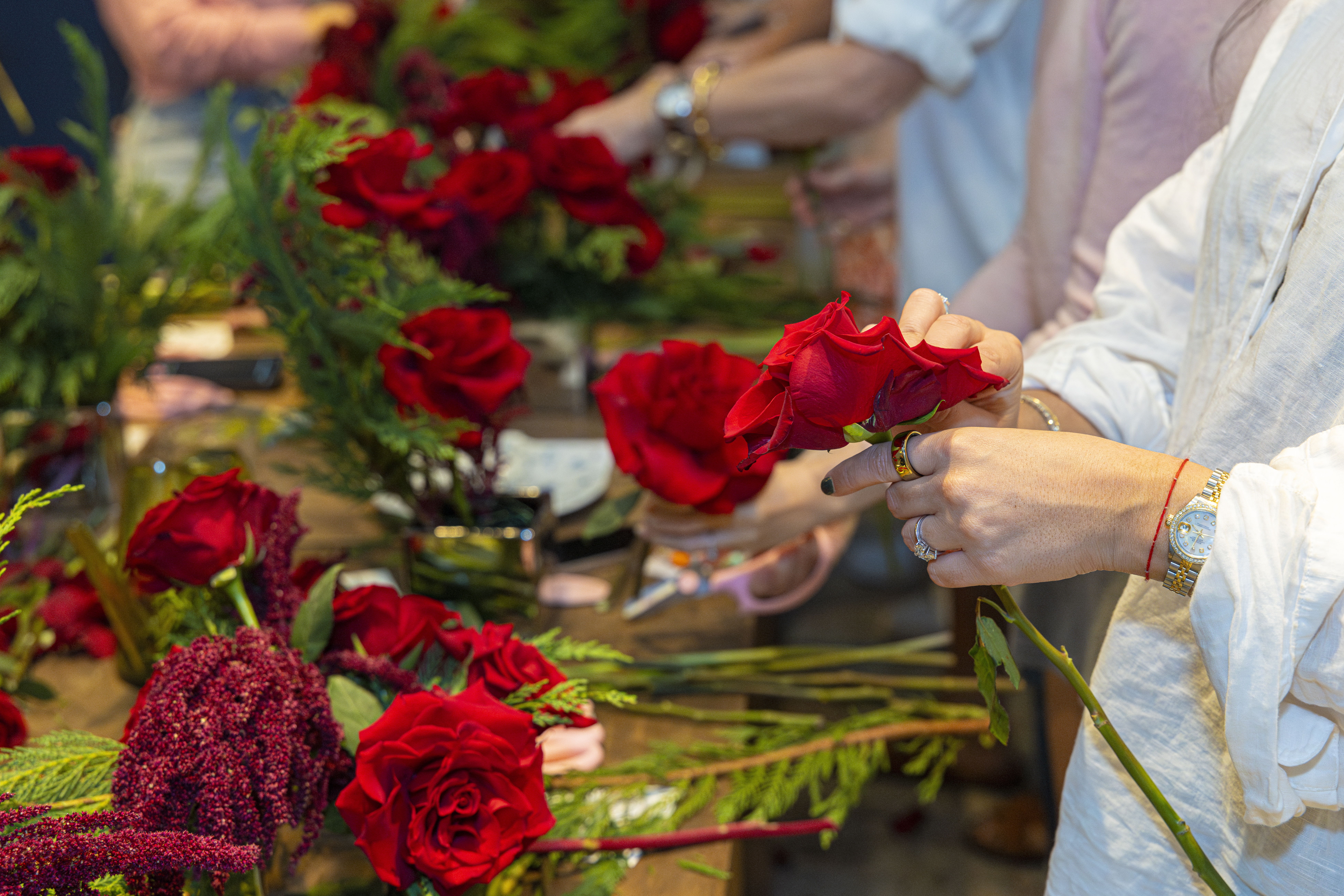 Woman making a bouquet of red flowers