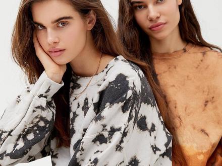 Two models posing in Urban Outfitters sweatshirts 