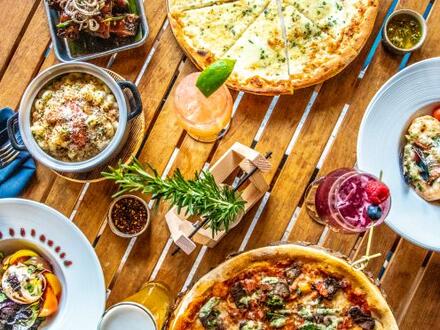 pizza and accompaniments on wooden table