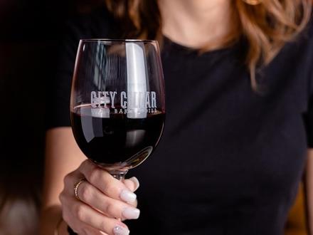 Woman holding glass of red wine 