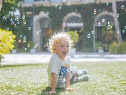 little boy playing with bubbles