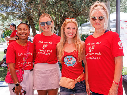 Four women in red shirts