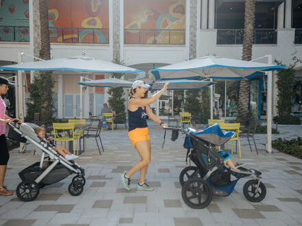 Mom walking with stroller doing workout