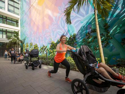 women pushing strollers