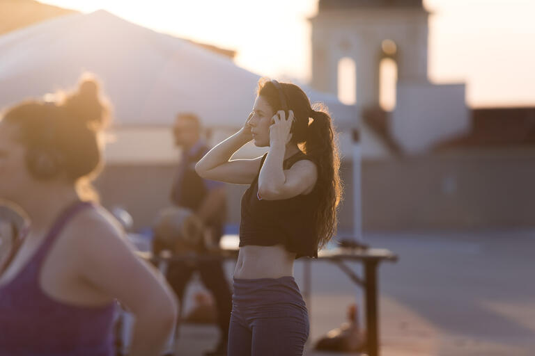 people outside with the sun in the background