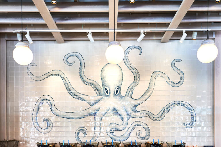 Restaurant interior featuring tiled octopus mural 