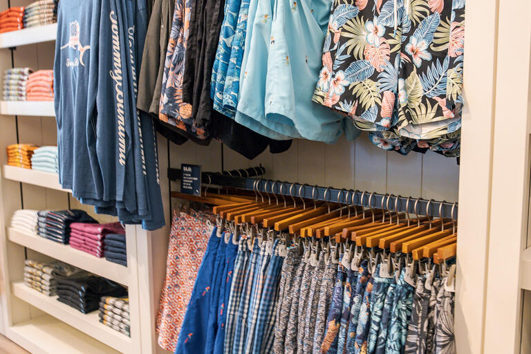 Racks of colorful men's swim trunks 