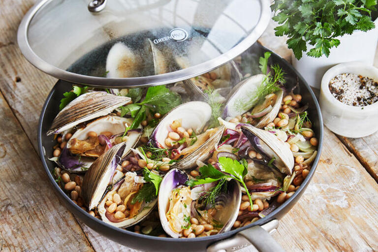 Pan filled with steamed clams and white beans