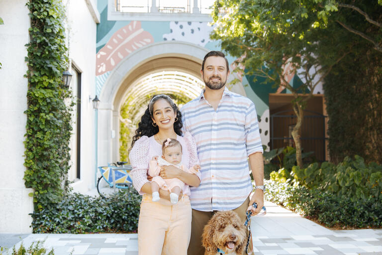 Family posing in front of Mural