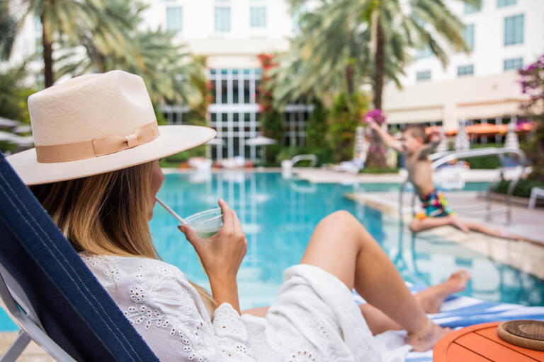 women sitting poolside at Hilton West Palm Beach