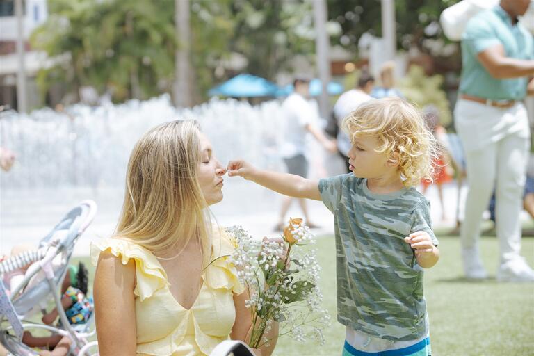 Childing giving his mother a flower to smell