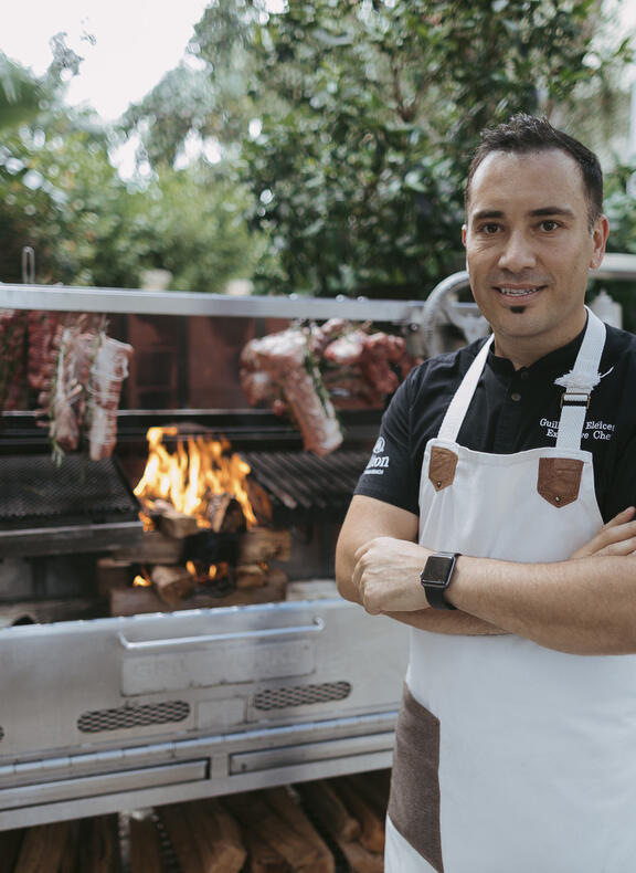 Chef standing in front of grill
