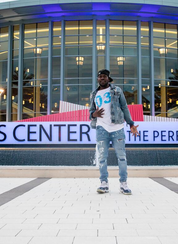 Man dancing in front of Kravis Center for the preforming arts 