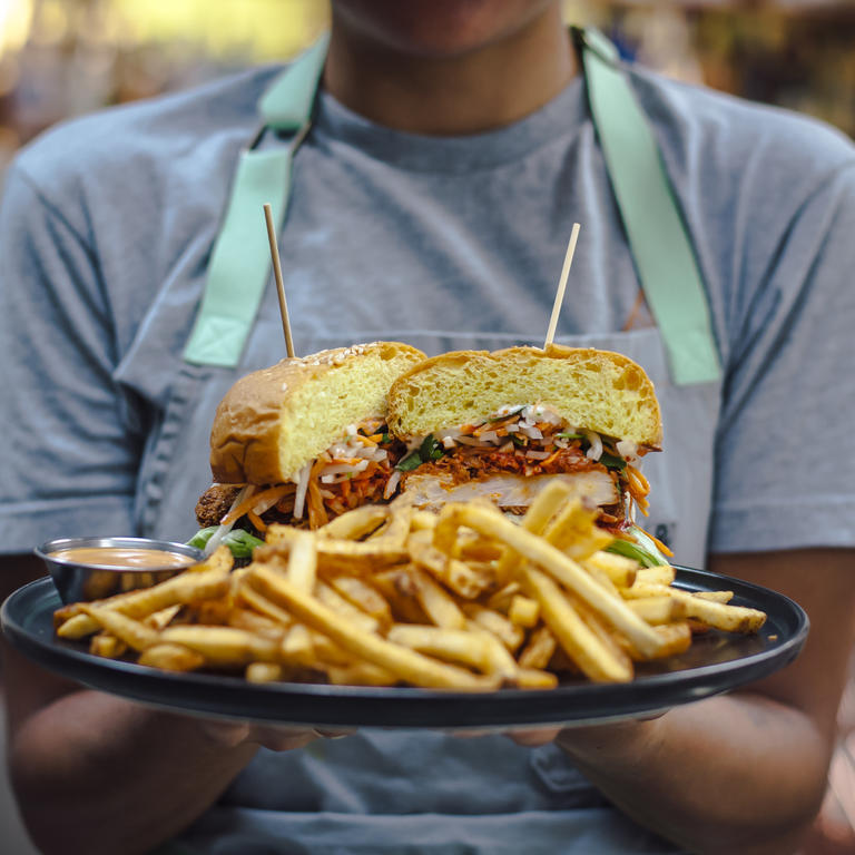 person holding sandwich up to camera