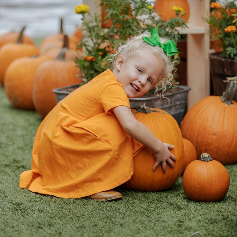 Girl hugging a pumpkin