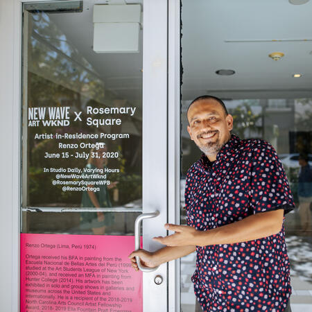 Artist standing in front of his studio