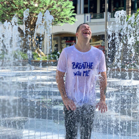 artist standing in fountain