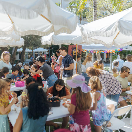 Crowd of people gather at the lawn  to do arts and crafts