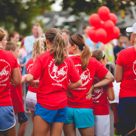 People standing in a circle in red shirts