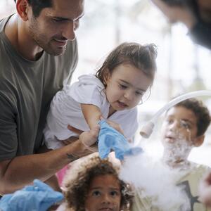 Family participating in science activity 